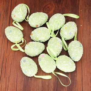 Set of 12 green Easter egg hanging ornaments with white foam dots and colorful floral patterns