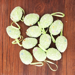 Detail of speckled foam Easter eggs with colorful flowers and green hanging ribbons