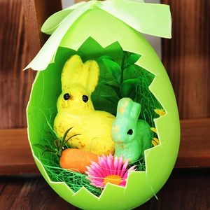 Detail of Easter egg shell container with cute toy bunnies and carrot decoration