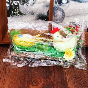 Detail of Easter chicken nest decoration with foam eggs and green clover inside packaging