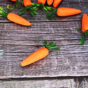 7cm foam Easter carrots with realistic texture on a dark wooden background