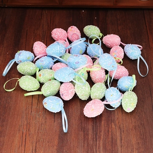 Detail of speckled foam Easter eggs with satin ribbons on a dark wooden background