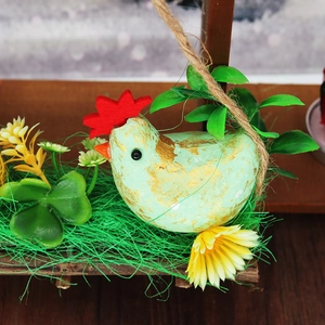 Pastel green Easter chicken figurine with gold foil accents and floral straw wreath base