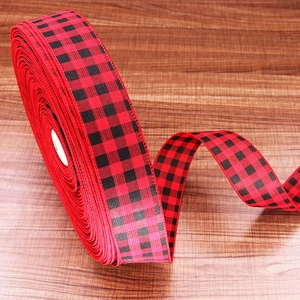 Detail of red and black buffalo plaid ribbon roll for Christmas gift wrapping