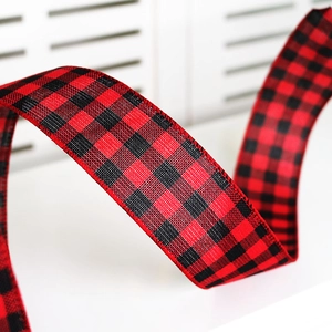 Close-up of classic red and black buffalo plaid ribbon with stitched edges for decoration