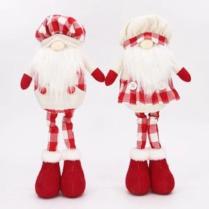 Close-up of a pair of Christmas gnomes in red plaid outfits with long legs on white background