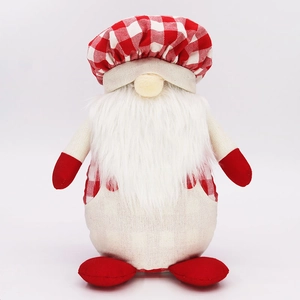 Detail of faceless chef gnome plush with red plaid hat and long white beard decoration