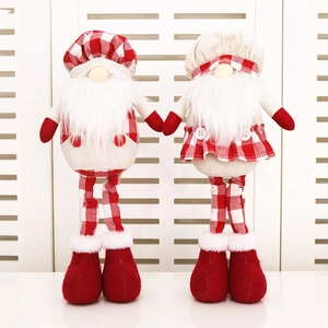 Macro detail of Christmas gnomes in red plaid fabric with long legs and white beards