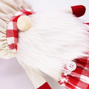 Detailed macro view of Christmas gnome featuring red plaid patterns and soft white beard