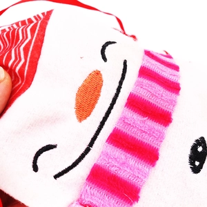 Christmas snowman gift bag with embroidery details and festive plush fabric decorations