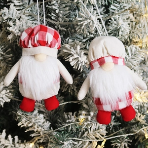 Hanging Christmas gnomes with long white beards and red plaid hats on a festive tree