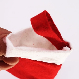 Mini red and white Christmas stocking holder for cutlery with plush trim and hanging loop