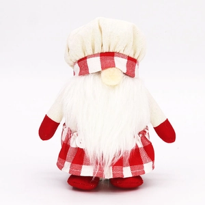 Close-up of fabric gnome chef in red checkered apron and white beard for Christmas