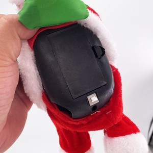 Electric musical Santa Claus plush toy with a visible battery compartment and power switch