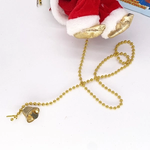 Close-up of Santa doll velvet costume with golden bead chain and small metal bell detail