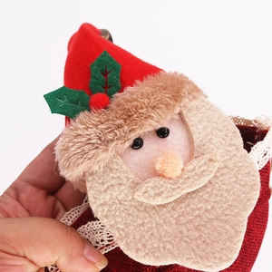 Detailed close-up of handmade Santa Claus burlap gift bag with red lace and 3D applique