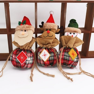 Three festive Christmas drawstring gift bags featuring Santa, elk, and snowman motifs