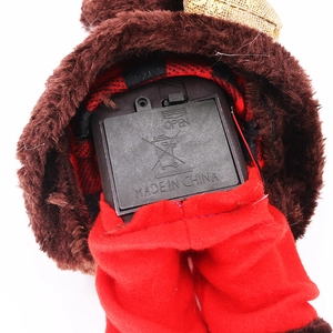 Detail of the bottom battery compartment on electric musical Santa Claus plush decor