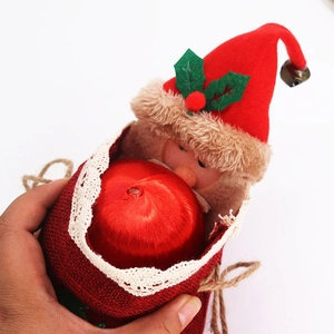 Detail of Santa Claus burlap gift bag with red hat, lace trim and a small metal bell