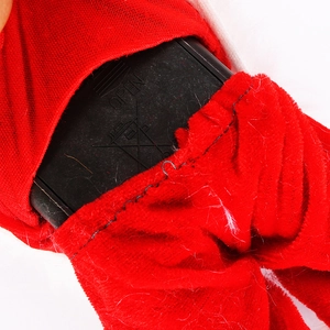 Detail view of the black plastic battery compartment on the red velvet Santa toy