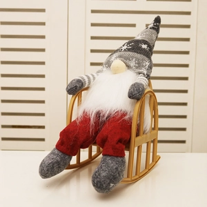 Christmas gnome plush toy with striped hat sitting on a yellow rocking chair