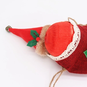 Close-up of Christmas linen gift bag with felt holly leaves and a small metal bell