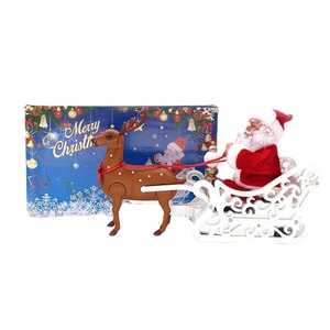 Electric Santa Claus sleigh toy with reindeer and a festive Merry Christmas gift box