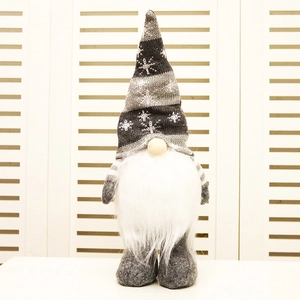 Detail of a Christmas gnome with grey striped knitted hat and soft white faux fur beard