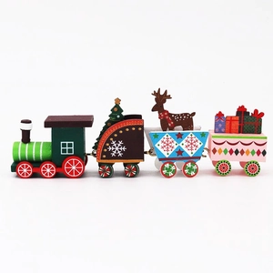 Green wooden Christmas train ornament with festive reindeer and tree on white background