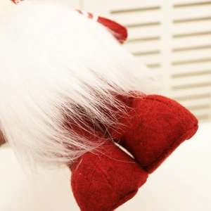 Detailed close-up of handmade white faux fur beard and red felt base of the Christmas gnome