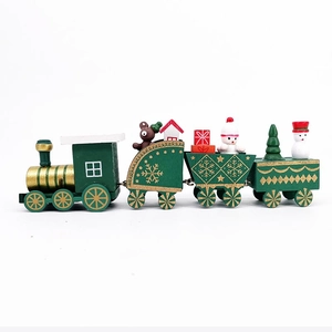Detail of wooden Christmas train with miniature figures like bears and snowmen on white background