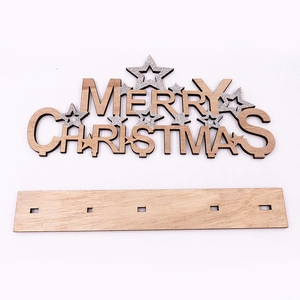 Detail of wooden Merry Christmas table sign with silver glitter stars and stand