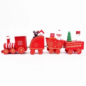 Detail of red wooden Christmas train set with bear, snowman and gift box ornaments