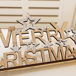 Detail of wooden Merry Christmas table decor with silver glitter stars and cutout letters