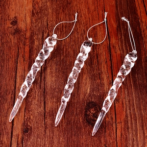Detailed view of three twisted clear acrylic icicle ornaments for Christmas tree decor
