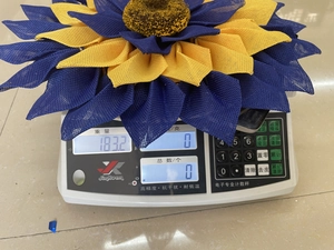 Handcrafted blue and yellow sunflower wreath with textured fabric petals for home decor
