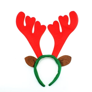 Detail of red Christmas reindeer antlers and brown ears on a green fabric headband