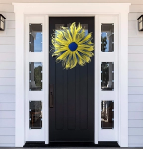 Ukraine prayer sunflower mesh wreath in yellow and blue hanging on a dark front door