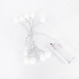Macro shot of white frosted LED cherry globes with transparent battery box and wiring