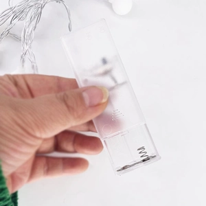 Close-up of a transparent battery box for LED string lights with an ON/OFF switch