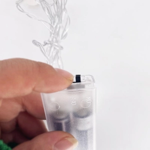 Detail of transparent 2AA battery box controller for LED string lights with on-off switch