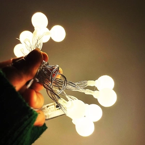 Close-up of frosted warm white LED globe string lights for festive holiday decoration