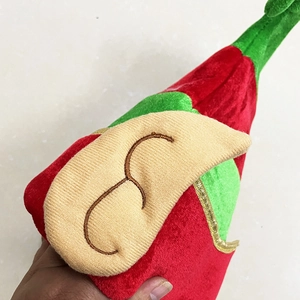 Red and green velvet Christmas elf hat with pointed ears and golden trim detail
