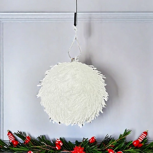 Close-up of 8cm white fuzzy Christmas ball ornament with silver string on a holiday tree branch
