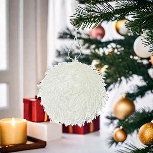 Close-up of 8cm white glitter foam Christmas ball with silver loop in festive setting