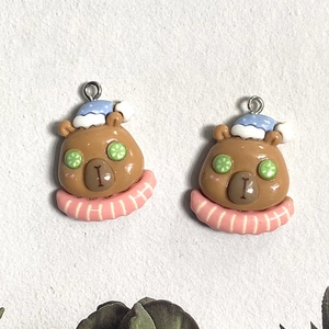 Detail of cute resin capybara charms with spa theme for DIY earring and keychain making