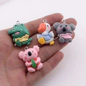 Close-up of resin animal charms showing crocodile, duck, and koala pendant details