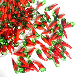Close-up of handmade red chili glass pendants for DIY jewelry and earring making