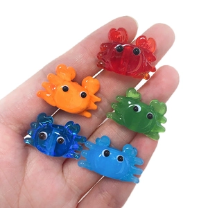 Close-up of colorful resin crab charms in red, orange, green and blue for jewelry making