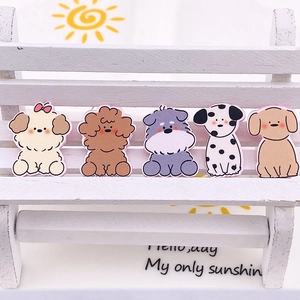 Macro detail of five cute cartoon puppy charms including Teddy and Schnauzer breeds